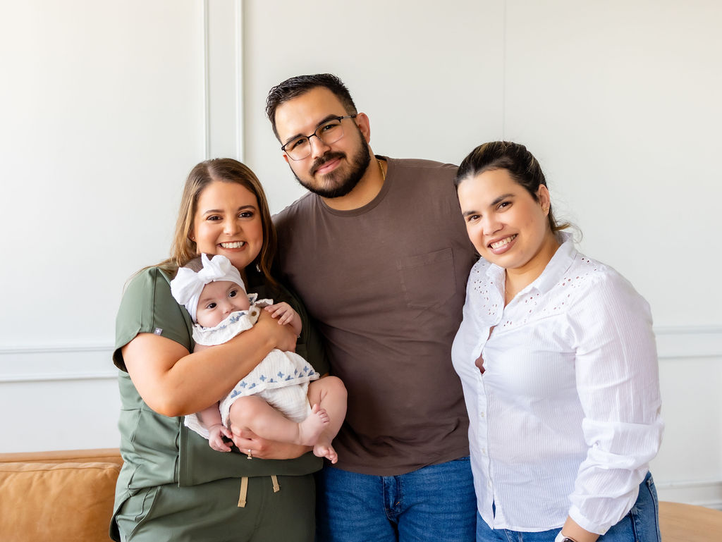 A family posing with Brittany Shockley, who holds their infant