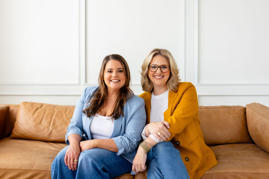 Co-founders Brittany Shockley and Ally Gore seated together on a sofa